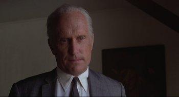 Movie still from “True Confessions” (1981), directed by Ulu Grosbard – An older man wearing a suit and tie; Close Up shot, Low angle