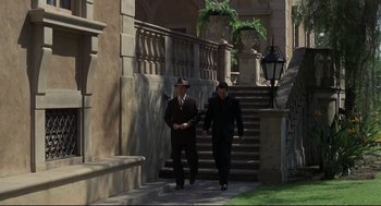 Movie still from “True Confessions” (1981), directed by Ulu Grosbard – A couple of men walking up a set of stairs; Wide shot, Low angle
