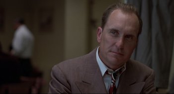 Movie still from “True Confessions” (1981), directed by Ulu Grosbard – A man in a suit and a tie; Close Up shot, Low angle