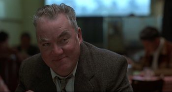 Movie still from “True Confessions” (1981), directed by Ulu Grosbard – A person wearing a suit and tie; Close Up shot, Low angle