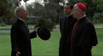 Movie still from “True Confessions” (1981), directed by Ulu Grosbard – A group of men standing next to each other in a field; Medium shot, Over the shoulder angle