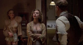 Movie still from “True Confessions” (1981), directed by Ulu Grosbard – A woman standing next to a man in front of a mirror; Medium shot, Over the shoulder angle