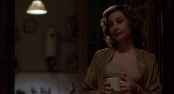 Movie still from “True Confessions” (1981), directed by Ulu Grosbard – A woman holding a coffee cup in her hands; Close Up shot, Over the shoulder angle