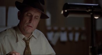 Movie still from “True Confessions” (1981), directed by Ulu Grosbard – A man wearing a hat and a tie; Close Up shot, Low angle