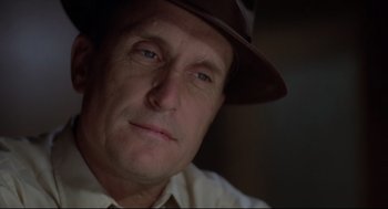 Movie still from “True Confessions” (1981), directed by Ulu Grosbard – A person wearing a hat and looking at the camera; Close Up shot, Low angle