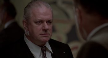 Movie still from “True Confessions” (1981), directed by Ulu Grosbard – An older man in a suit and tie looking to his left; Close Up shot, Low angle