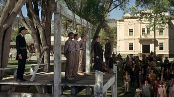 Movie still from “True Grit” (1969), directed by Henry Hathaway – A group of men standing on top of a wooden platform; Wide shot, Low angle