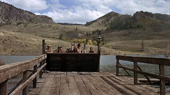 Movie still from “True Grit” (1969), directed by Henry Hathaway – A group of people on a boat in the water; Extreme Wide shot, High angle