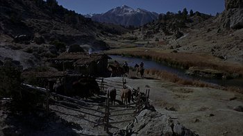 Movie still from “True Grit” (1969), directed by Henry Hathaway – A group of people riding horses next to a body of water; Extreme Wide shot, High angle