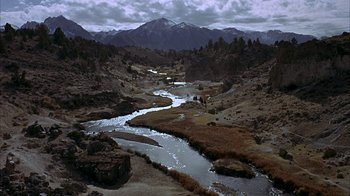 Movie still from “True Grit” (1969), directed by Henry Hathaway – A river running through the middle of the desert; Extreme Wide shot, High angle