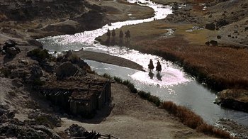 Movie still from “True Grit” (1969), directed by Henry Hathaway – A group of people riding horses across a river; Extreme Wide shot, High angle