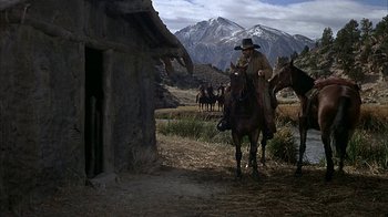 Movie still from “True Grit” (1969), directed by Henry Hathaway – A man on a horse in the middle of a field; Wide shot, Low angle