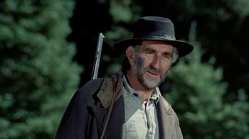 Movie still from “True Grit” (1969), directed by Henry Hathaway – An older man with a hat and a gun; Close Up shot, Low angle