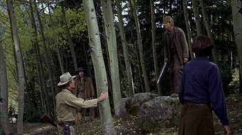 Movie still from “True Grit” (1969), directed by Henry Hathaway – A group of people standing around a tree; Wide shot, Over the shoulder angle