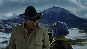Movie still from “True Grit” (1969), directed by Henry Hathaway – A man and a woman in a cowboy hat; Medium shot, Over the shoulder angle