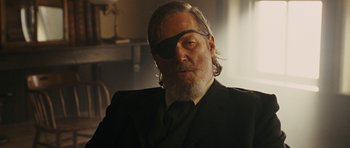 Movie still from “True Grit” (2010), directed by Ethan Coen – A man wearing a suit and a eye patch; Close Up shot, Over the shoulder angle