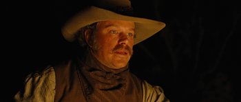 Movie still from “True Grit” (2010), directed by Ethan Coen – A man with a cowboy hat and a beard; Close Up shot, Low angle