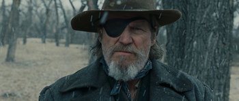 Movie still from “True Grit” (2010), directed by Ethan Coen – A person wearing a hat with a eye patch; Close Up shot, Low angle