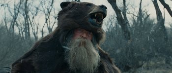 Movie still from “True Grit” (2010), directed by Ethan Coen – A man with a beard and a bear costume; Close Up shot, Low angle