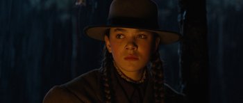 Movie still from “True Grit” (2010), directed by Ethan Coen – A young girl with braids wearing a hat; Close Up shot, Low angle