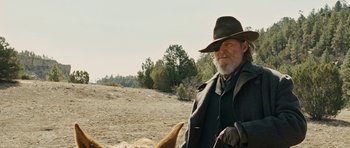 Movie still from “True Grit” (2010), directed by Ethan Coen – An old man with a long white beard wearing a hat; Medium shot, Low angle