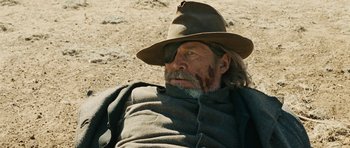 Movie still from “True Grit” (2010), directed by Ethan Coen – An old man with a beard and a cowboy hat; Close Up shot, Low angle