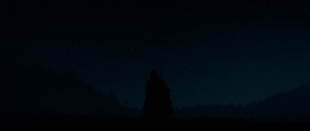 Movie still from “True Grit” (2010), directed by Ethan Coen – A person standing in the dark under a night sky; Extreme Wide shot, Low angle