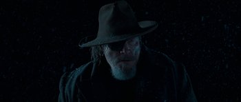 Movie still from “True Grit” (2010), directed by Ethan Coen – A man wearing a hat and a jacket; Close Up shot, Low angle