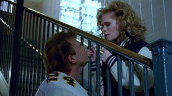 A man and a woman on a stair rail