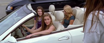 Movie still from “Trust” (2010), directed by David Schwimmer – Three young women sitting in the back seat of a white car; Medium shot, High angle