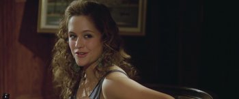 Movie still from “Trust” (2010), directed by David Schwimmer – A beautiful woman with long curly brown hair posing; Close Up shot, Over the shoulder angle