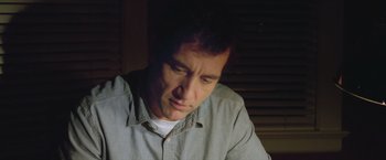 Movie still from “Trust” (2010), directed by David Schwimmer – A person wearing a gray shirt; Close Up shot, Low angle