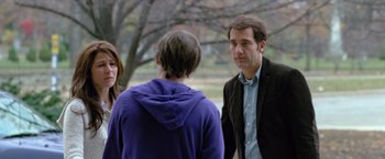 Movie still from “Trust” (2010), directed by David Schwimmer – A group of people standing next to each other on a field; Medium shot, Over the shoulder angle