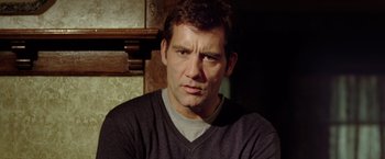 Movie still from “Trust” (2010), directed by David Schwimmer – A person wearing a gray shirt; Close Up shot, Low angle