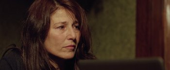 Movie still from “Trust” (2010), directed by David Schwimmer – A person with long brown hair; Close Up shot, Over the shoulder angle