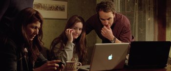 Movie still from “Trust” (2010), directed by David Schwimmer – A man and a woman looking at a computer screen; Medium shot, Over the shoulder angle