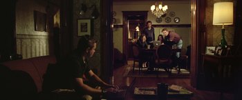 Movie still from “Trust” (2010), directed by David Schwimmer – A group of people in a living room using laptops; Wide shot, High angle