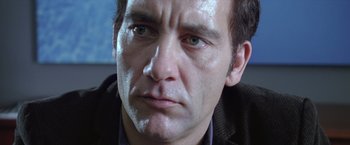 Movie still from “Trust” (2010), directed by David Schwimmer – A man's face in a black jacket; Extreme Close Up shot, Low angle
