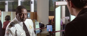 Movie still from “Trust” (2010), directed by David Schwimmer – A man standing in front of a gate; Close Up shot, Over the shoulder angle