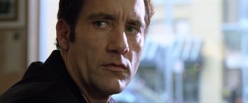 Movie still from “Trust” (2010), directed by David Schwimmer – A man's face in a room; Close Up shot, Low angle