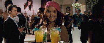 Movie still from “Trust” (2010), directed by David Schwimmer – A woman in a pink hat holding a tray of drinks; Close Up shot, Over the shoulder angle