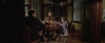 Movie still from “Trust” (2010), directed by David Schwimmer – A group of people sitting at a table with wine; Wide shot, High angle
