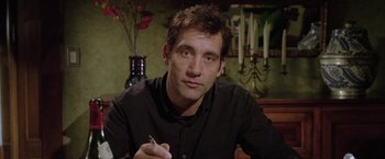 Movie still from “Trust” (2010), directed by David Schwimmer – A person sitting at a table writing; Close Up shot, Low angle