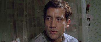 Movie still from “Trust” (2010), directed by David Schwimmer – A person wearing a gray shirt; Close Up shot, Low angle