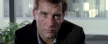 Movie still from “Trust” (2010), directed by David Schwimmer – A person wearing a suit and tie; Close Up shot, Low angle