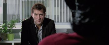 Movie still from “Trust” (2010), directed by David Schwimmer – A person wearing a suit and tie; Close Up shot, Over the shoulder angle