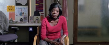 Movie still from “Trust” (2010), directed by David Schwimmer – A woman sitting in a chair in front of a mirror; Medium shot, Over the shoulder angle