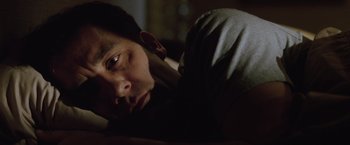 Movie still from “Trust” (2010), directed by David Schwimmer – A man laying on a bed with his head on his pillow; Close Up shot, Low angle