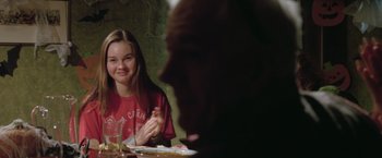 Movie still from “Trust” (2010), directed by David Schwimmer – A woman sitting at a table in front of an older man; Medium shot, Over the shoulder angle