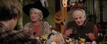 Movie still from “Trust” (2010), directed by David Schwimmer – Two people sitting at a table with a glass of wine; Medium shot, High angle